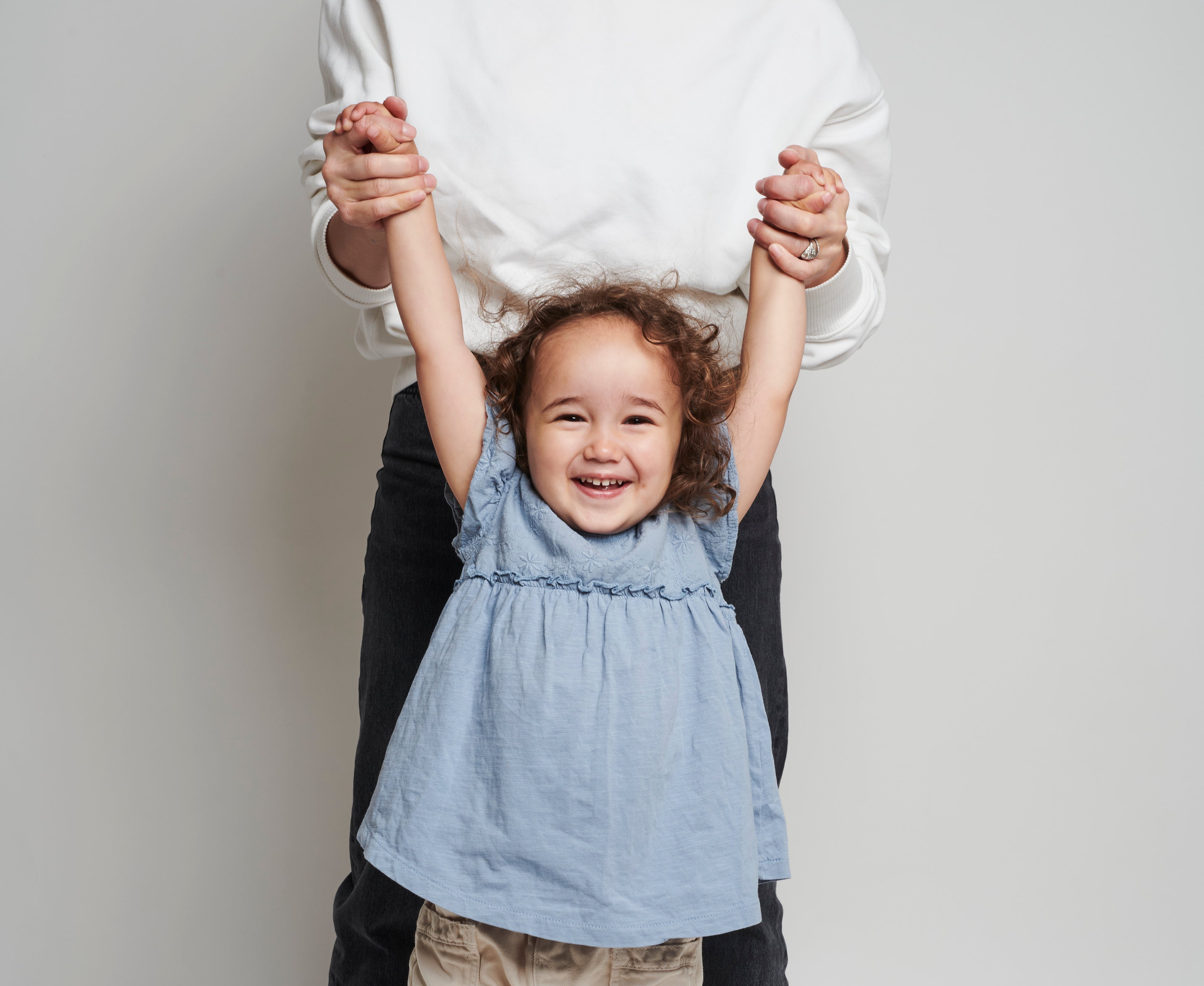 A child with her arms in the air celebrating our range of nut butter jars to safely introduce to your little one